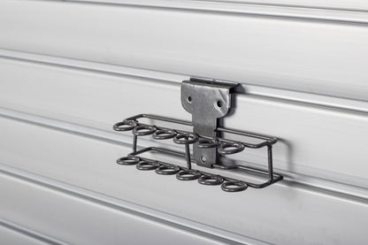 Metal storage rack attached to a white wall